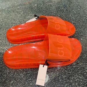 Authentic Gucci Men’s bright orange plastic sliders